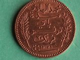 a close up of a coin on a green surface
