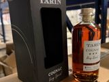 a bottle of cognac next to a cardboard box