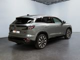 the rear view of a silver suv parked in a large room