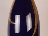a large blue vase with a gold design on it
