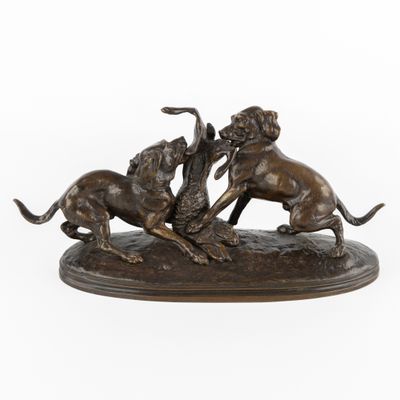 une image représentant une statue en bronze de deux chiens en train de se battre