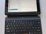 a tablet computer sitting next to a laptop computer on a table