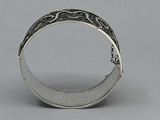 an antique silver ring with a design on the inside of it