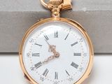 a gold pocket watch with roman numerals on it