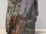 a sculpture of a rock on a table with a white wall in the background