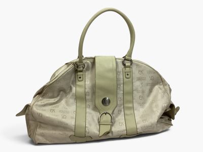 beige leather handbag on a white surface with a white background