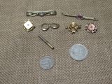 a small amount of jewelry on a table next to a penny