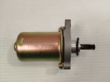 a small motor with a metal housing on a white surface