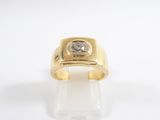 a close up of a gold ring with a diamond on it