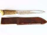 a knife and a sheath on a white surface