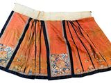 an orange and black skirt with a floral design on it