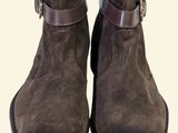 the boots are brown and black with a buckle on each side