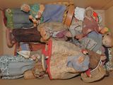 a cardboard box filled with many different types of dolls