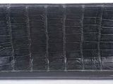 crocodile skin leather wallet with gold studs on a white background