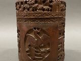an old wooden box with carvings on it sitting on a table