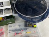 a mesh basket full of fishing gear on a table
