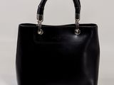 the small black bag has a bamboo handle on the handle