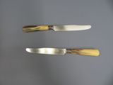 two knives that are sitting next to each other on a table