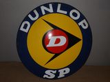 an image of a round sign with the word dunlop sp on it