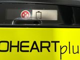 a close up of a yellow sign with the words heart plus on it