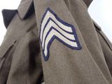 a military uniform with a blue and white chevron on it