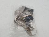 two keys in a plastic bag on a white surface