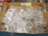 a box full of clear plastic bottles on a table