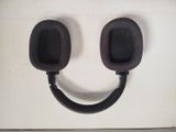 a pair of black headphones on a white surface