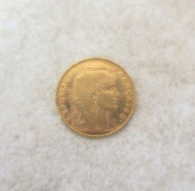 a gold coin sitting on top of a white surface
