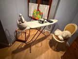 a small ironing board and a chair in a room