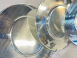 three silver plates sitting on top of each other