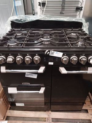 un poêle noir posé sur une palette dans un magasin