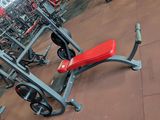 a red bench in the middle of a gym