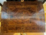 a wooden box with a design on it on a table