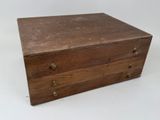 an old wooden box sitting on top of a white table