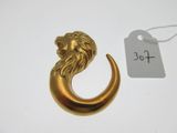 une image représentant une tête de lion en or surmontant un croissant en or