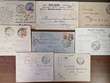 several old envelopes are sitting on a table with a lot of stamps