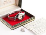 a box with a watch inside of it on a table