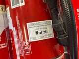 fire extinguisors are lined up on a shelf in a store
