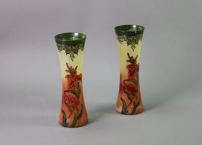 two vases with flowers painted on them on a table