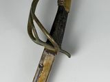 an image of a sword with a handle on a white surface