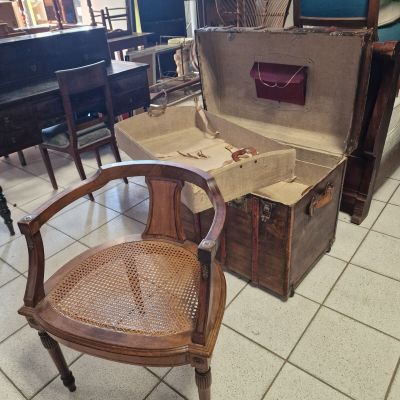 a chair that is sitting in front of an open suitcase