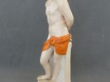a figurine of a man sitting on a toilet
