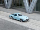 a small blue car parked on the side of the road
