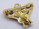 an image of a close up of a brooch with a butterfly on it