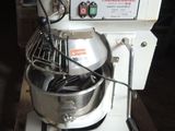 a white mixer sitting on a pallet in a warehouse