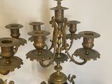 a lot of brass and blue vases on a table