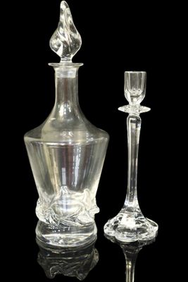 a glass decanter and a wine glass on a black background