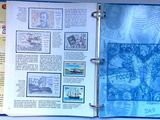 an open book with stamps on it on a table