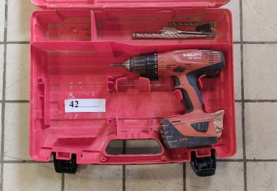 a pink tool box with tools in it on a tiled floor